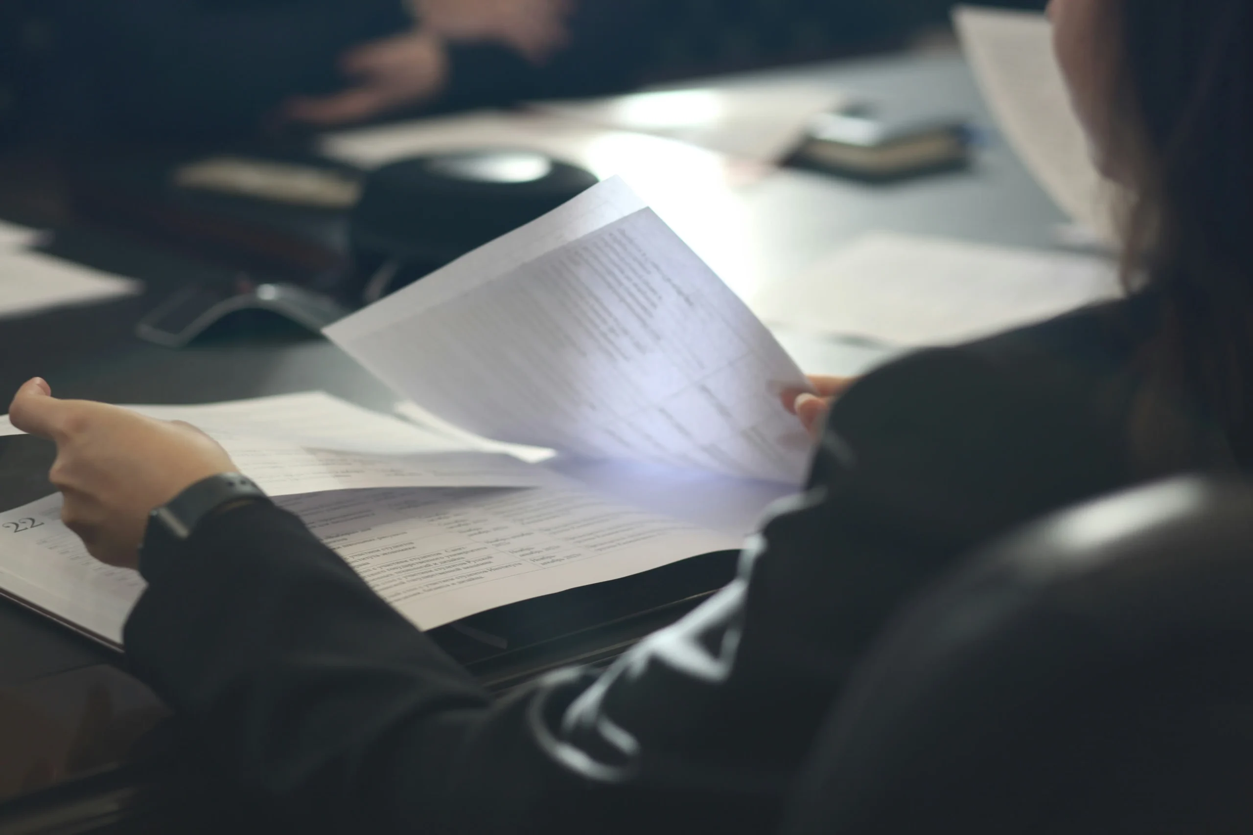 Professional reviewing documents for a COP9 forensic disclosure report